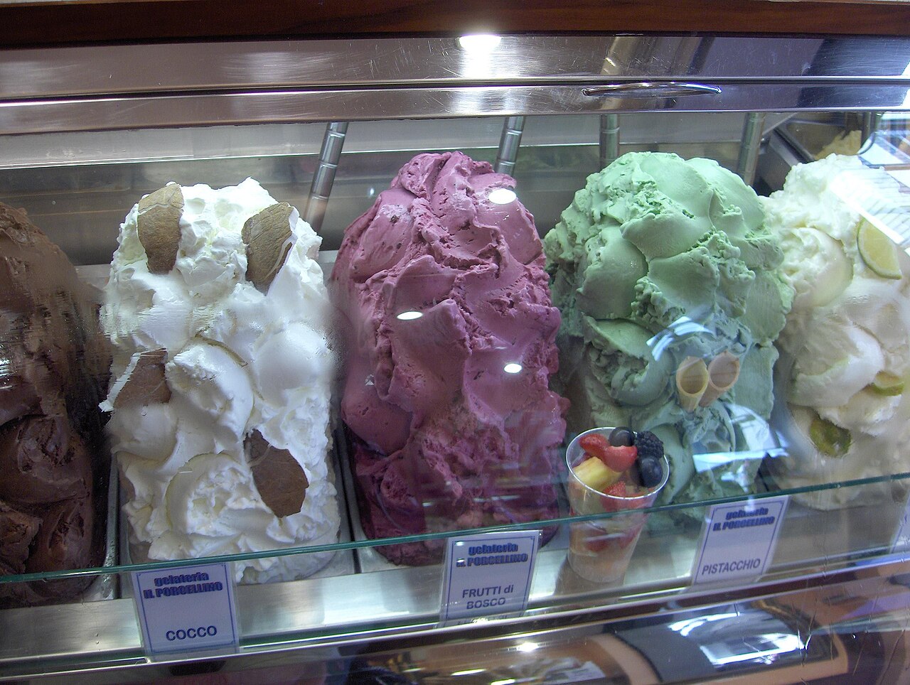 A gelato display case in Florence with rows of colourful flavours