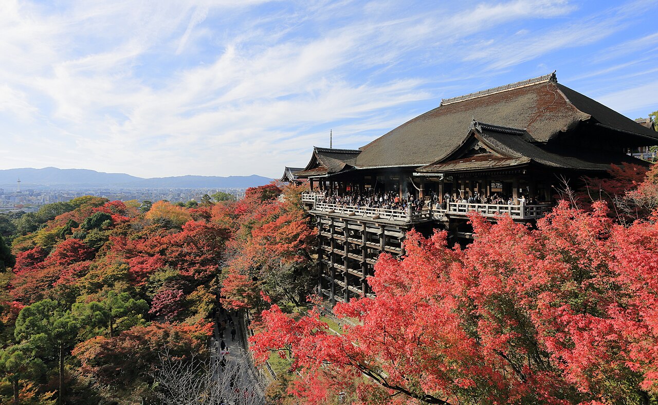 Kiyomizu-dera temple in Kyoto surrounded by red and gold autumn maple leaves