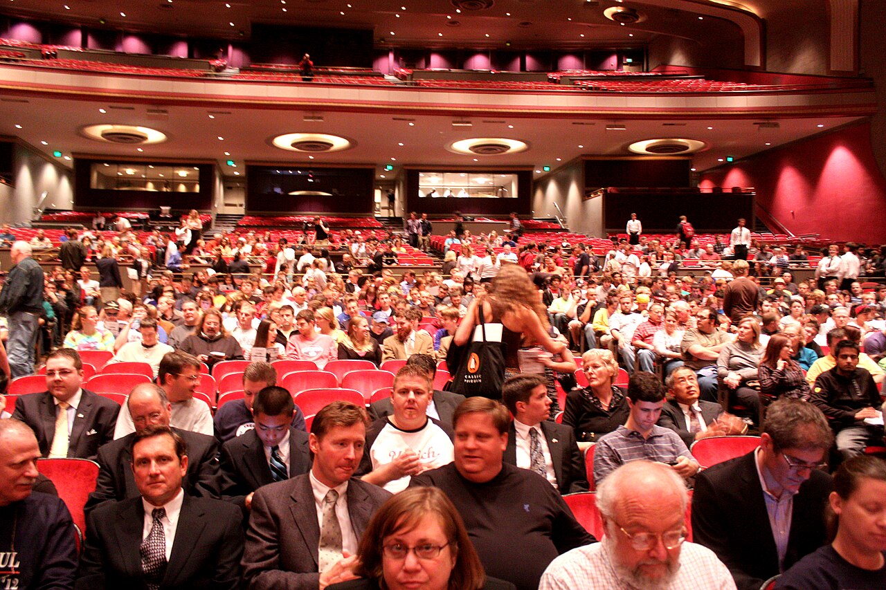 A full auditorium audience seen from the stage