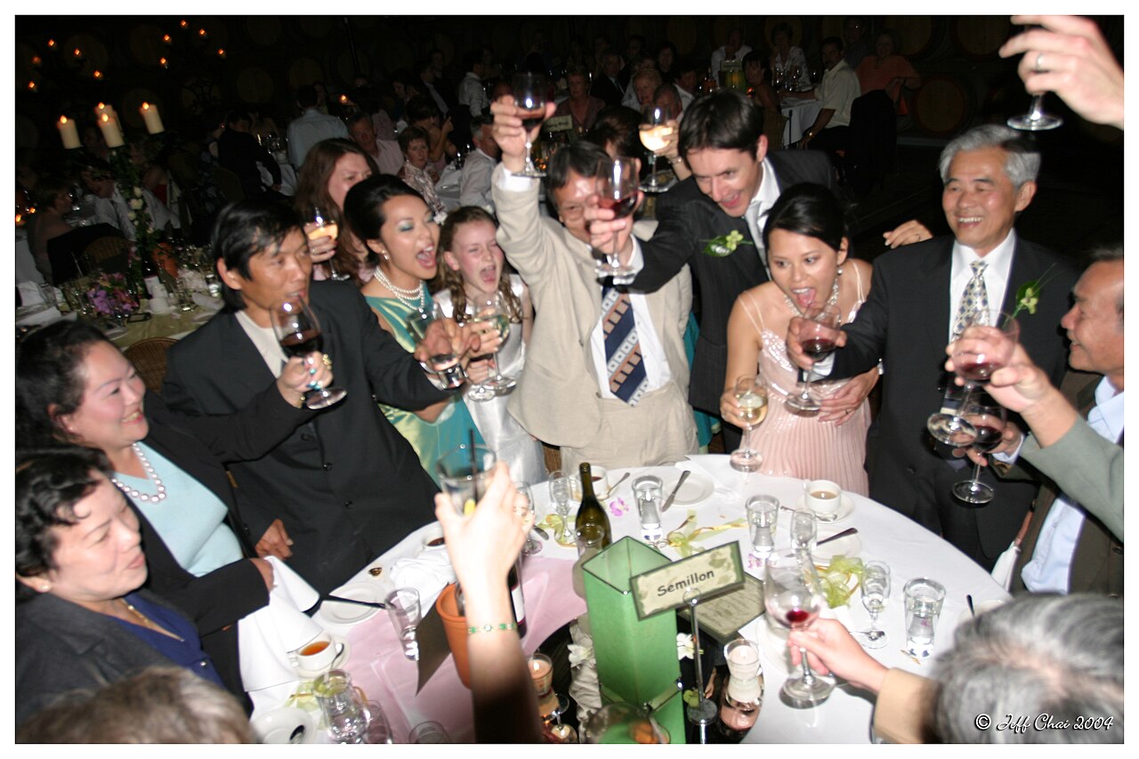 Guests raising glasses in a wedding toast